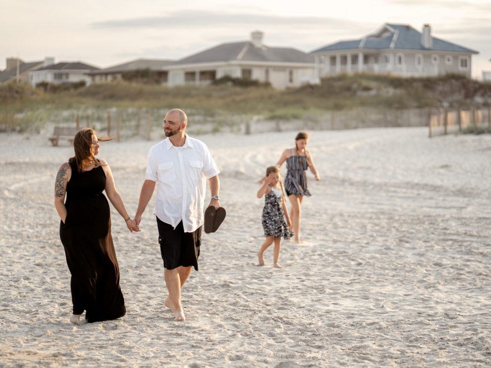 Portrait of a family walking on the at Wrightsville Beach captured by Wilmington, NC family photographer Salty Star Photography