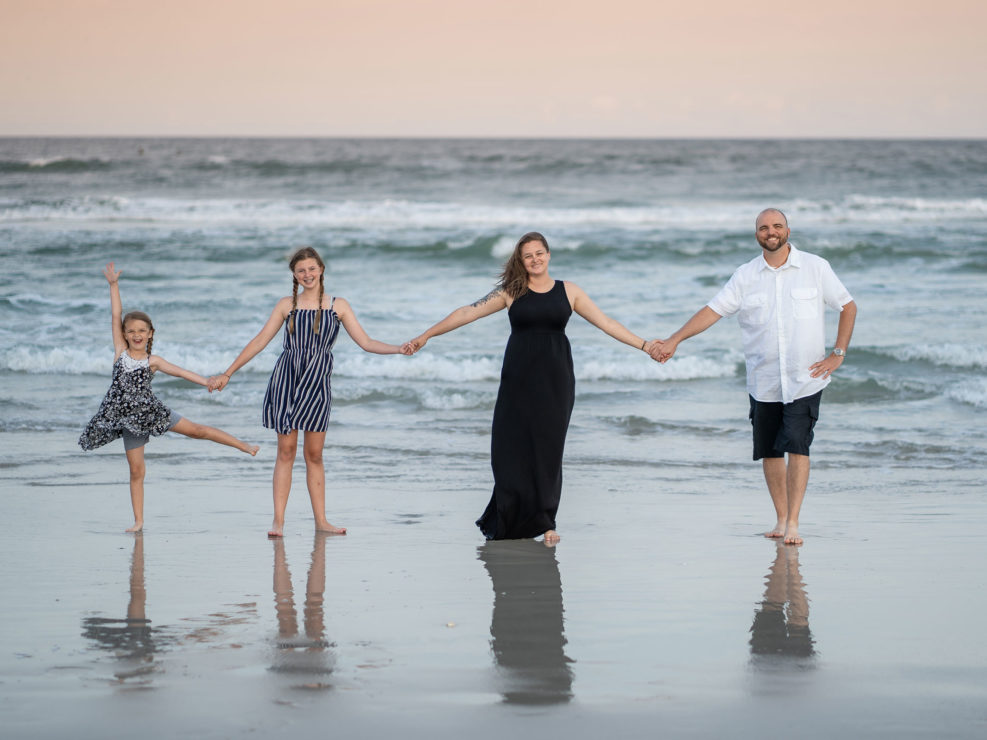 Portrait of a family standing by the ocean at Wrightsville Beach captured by Wilmington, NC family photographer Salty Star Photography