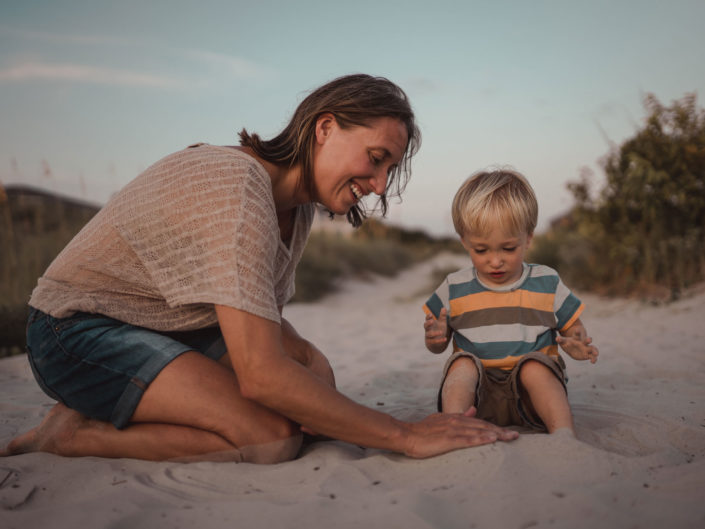 Portrait of a mother and son playing in the sand at Wrightsville Beach captured by Wilmington, NC family photographer Salty Star Photography
