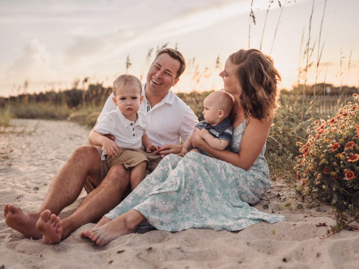 Family Portrait by the blooming blanket flowers on the beach at Fort Fisher, NC captured by Salty Star Photography